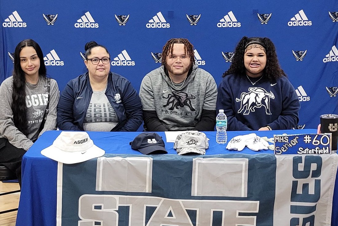 Matanzas defensive lineman Jackson Saterfield (center) with sisters Erika Pourier (left) and Tyra Saterfield (right) and mom Halona Pourier. Saterfield signed with Utah State. Courtesy photo