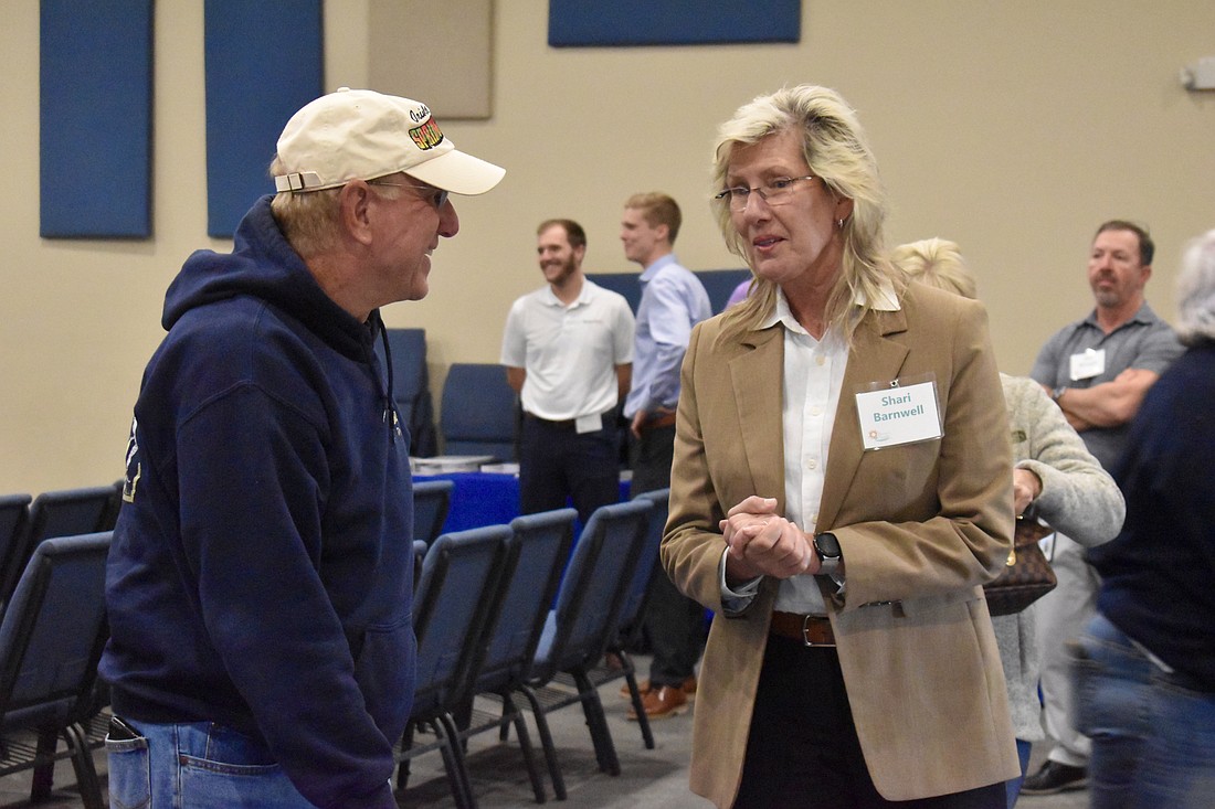 Twin Rivers resident Tom Thayer speaks with Kimley-Horn's Shari Barnwell. Barnwell is the project manager on the design of Fort Hamer Road.