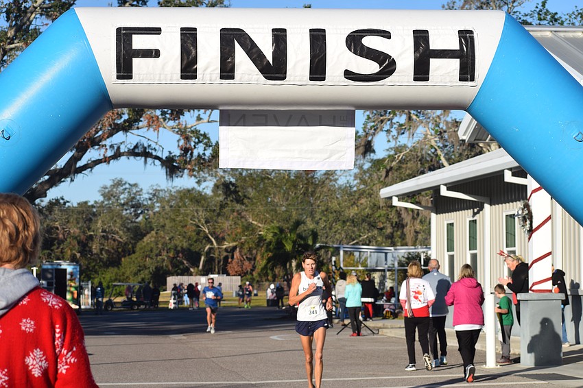 Heather Butcher of Nokomis was the first female runner to cross the finish line at Saturday's Jingle Jog 5K with a time of 19:53.20.