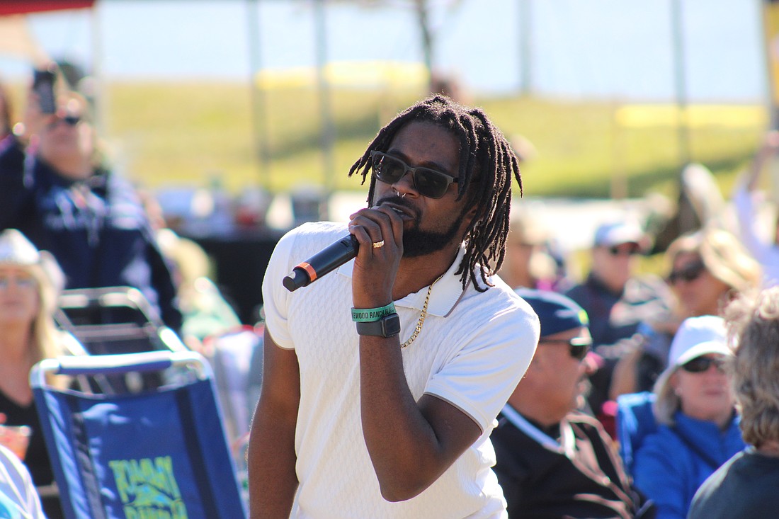 Blues artist Dylan Triplett ventures into the crowd to perform at the Lakewood Ranch Blues Festival.