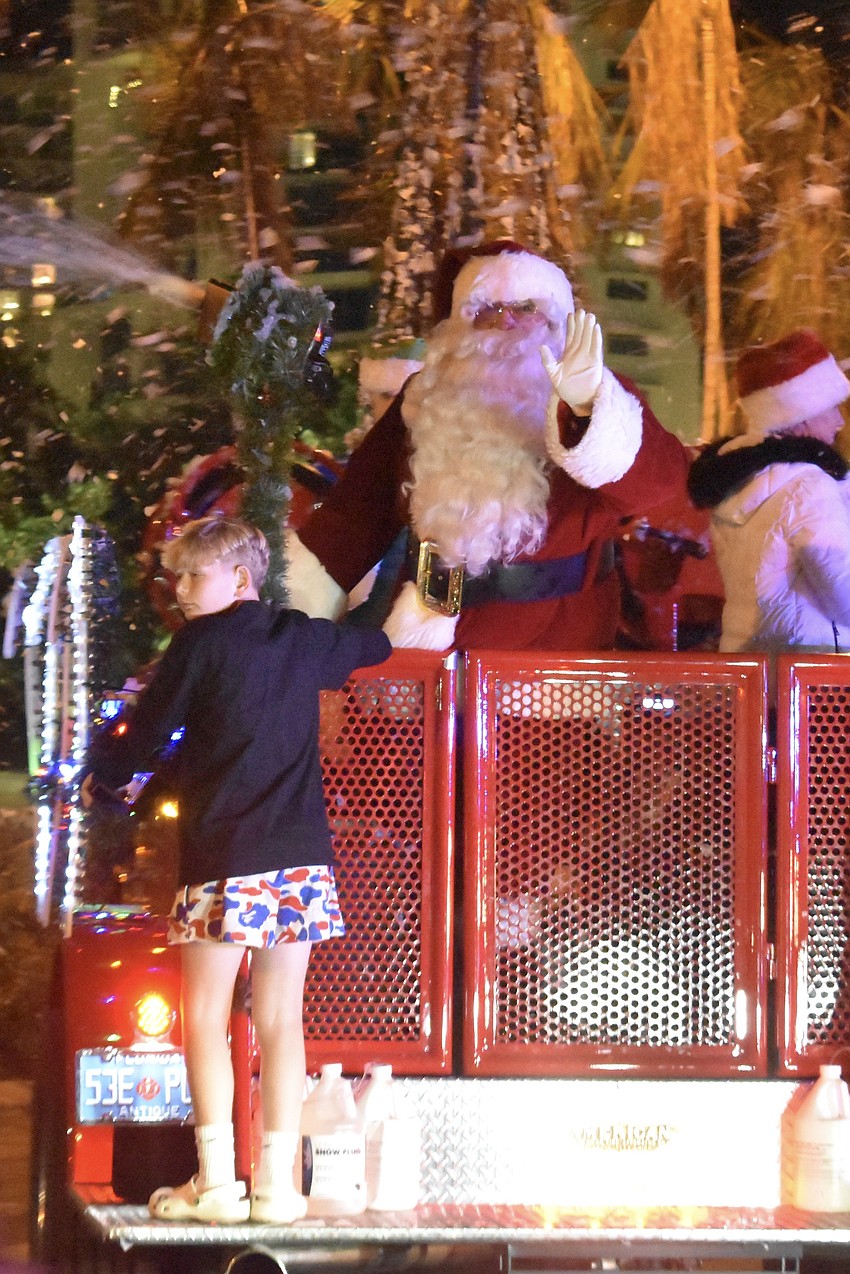 Santa Claus arrives as the parade ends.