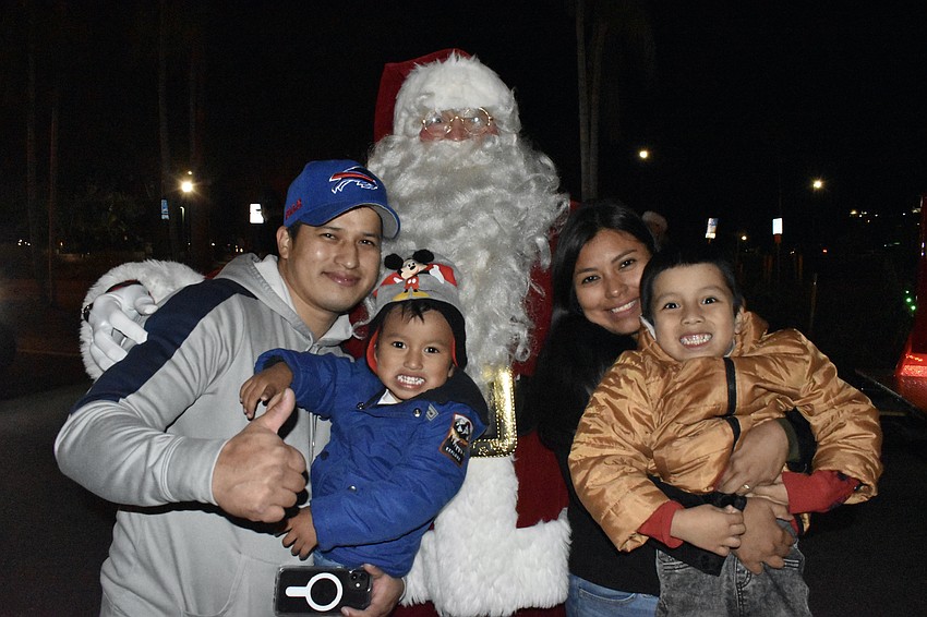 Hans Ocampo, Oliver Ocampo, 2, Yahoira Ocampo and Dominic Ocampo, 4, meet Santa Claus.
