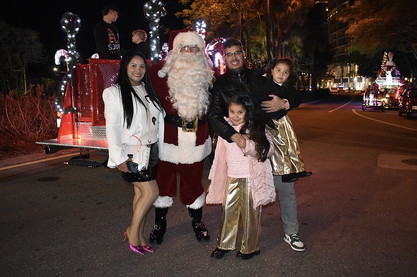 Madda Romero, Bella Romero, 6, Jorge Romero and Megha Romero, 2, meet Santa Claus.