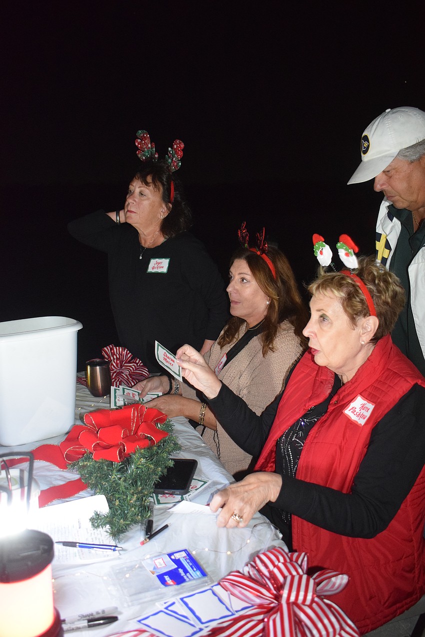 Joyce Hecklau, Abbe Catapano and Karen Pashkow checked residents in.