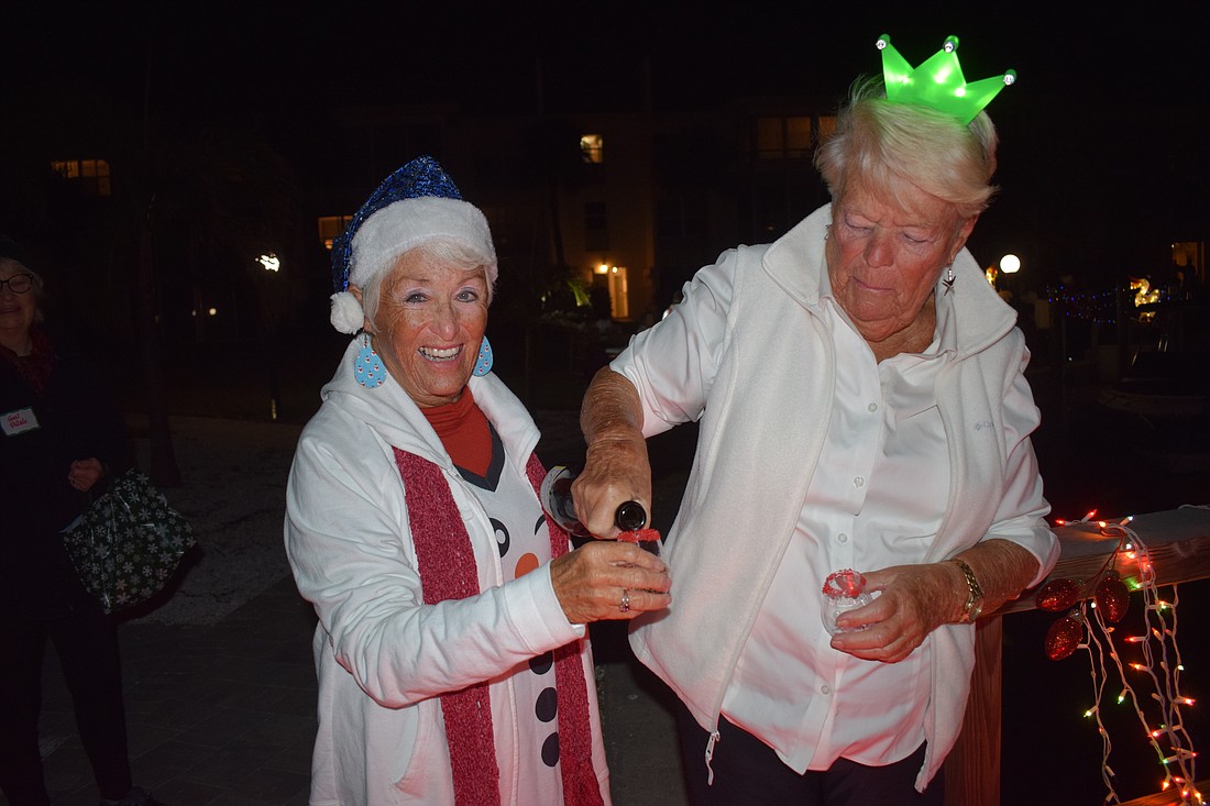Pat Marschke poured Prosecco for Connie DiMaggio.