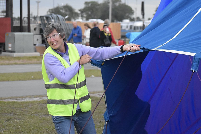 Ruskin volunteer Sue Gippert helps open the RE/MAX balloon.