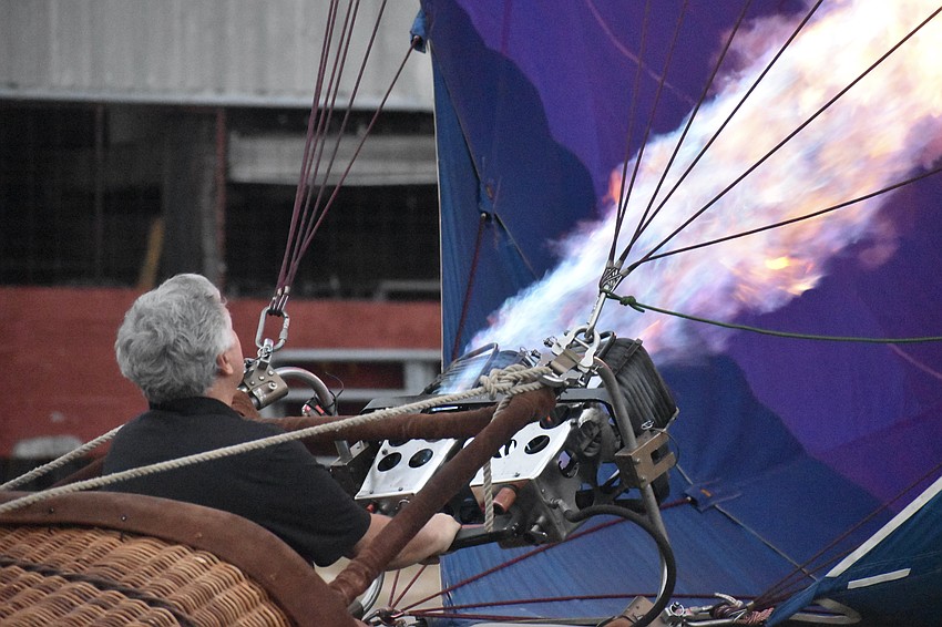 Fred Vereb of Tampa Ballooning Adventures brings the RE/MAX balloon to a standing position.