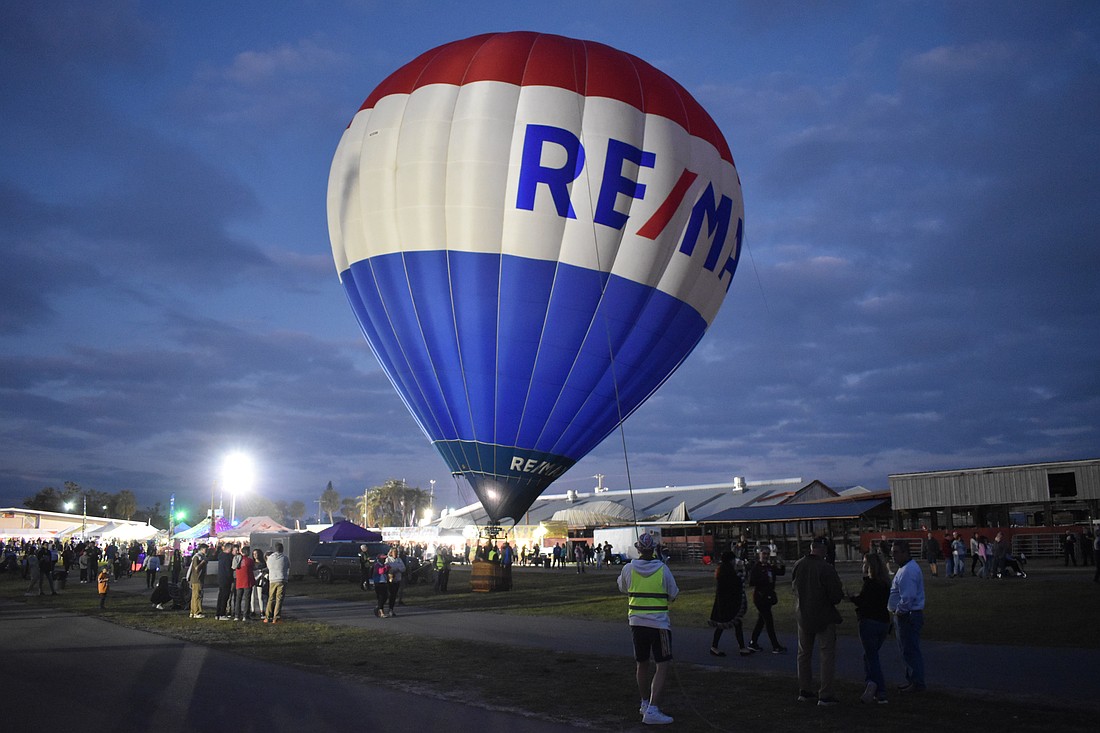 Sarasota volunteer Ken Junkins helps stabalize the RE/MAX balloon.