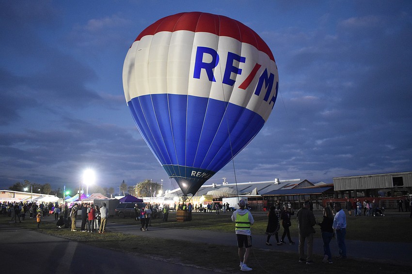 Sarasota volunteer Ken Junkins helps stabalize the RE/MAX balloon.