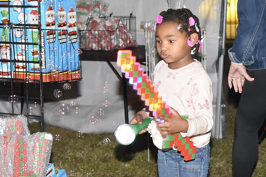 Liliana Desaro, 5, enjoys the bubbles that filled the event.