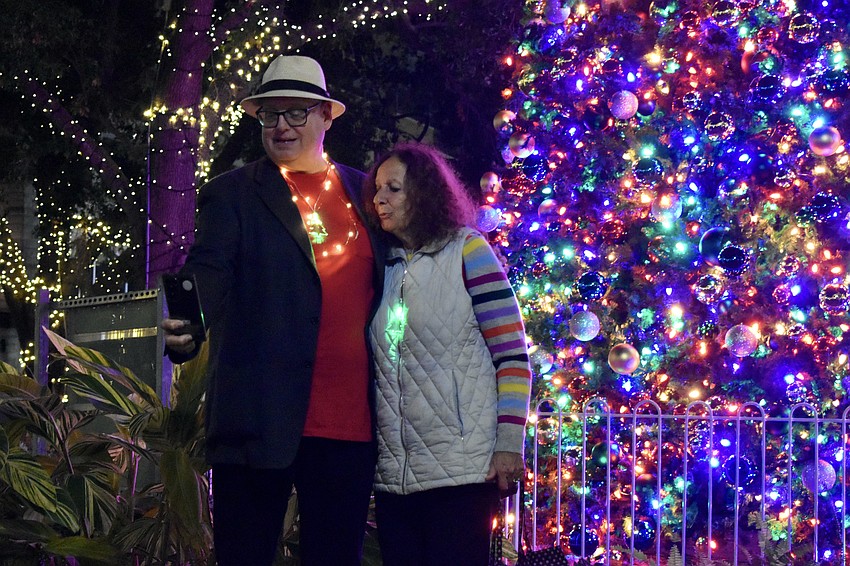 Bob and Ruth Firth take a selfie in front of the tree. 