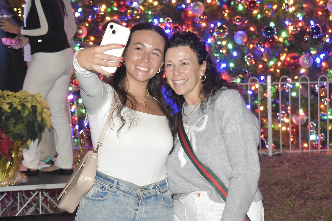 Lauren and Kim Smith, visitors from Pennsylvania, pose for a selfie in front of the tree.