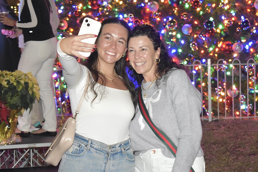 Lauren and Kim Smith, visitors from Pennsylvania, pose for a selfie in front of the tree.