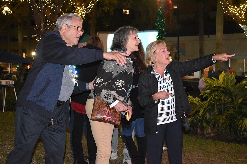 Emilio Mila, May Ann Dewes and Brenda Brown look at the new tree.