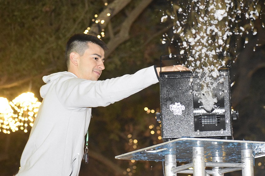 Nick Grano fills the snow machine.