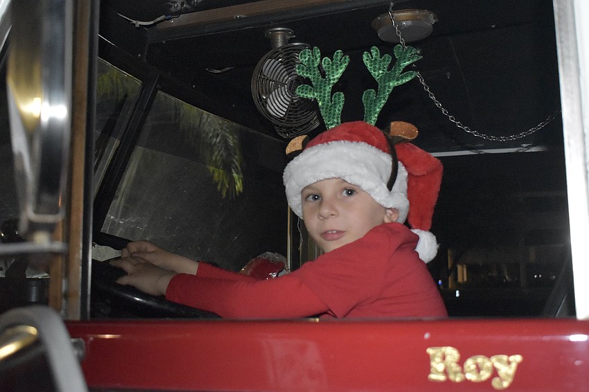 David Bartos, 5, sits in the driver's seat of a fire engine.