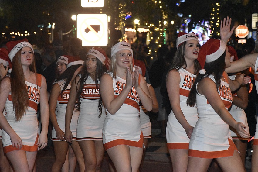 Sarasota High School cheerleaders walk in the parade.