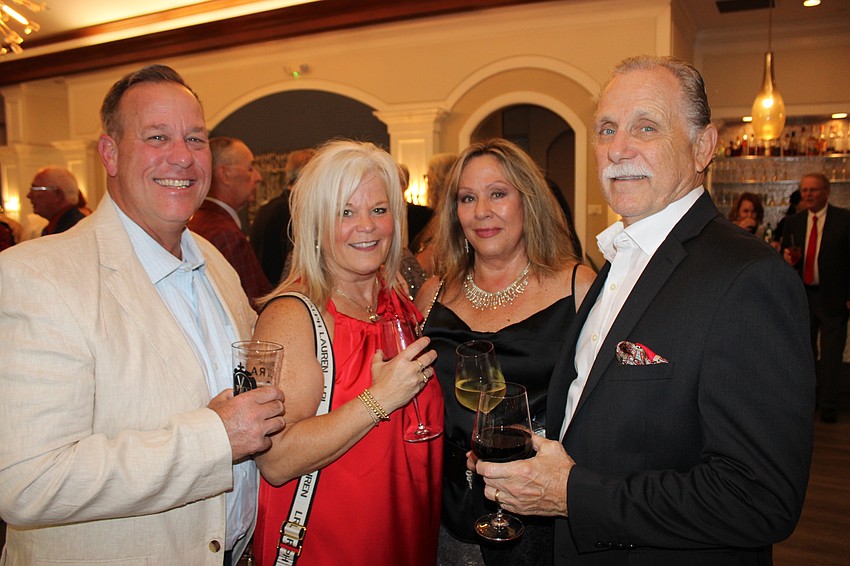 Dave and Shannon Eakle join Mary and Al McNicola at the River Club's Rockin' Reindeer Ball Dec. 8 at University Park Country Club.