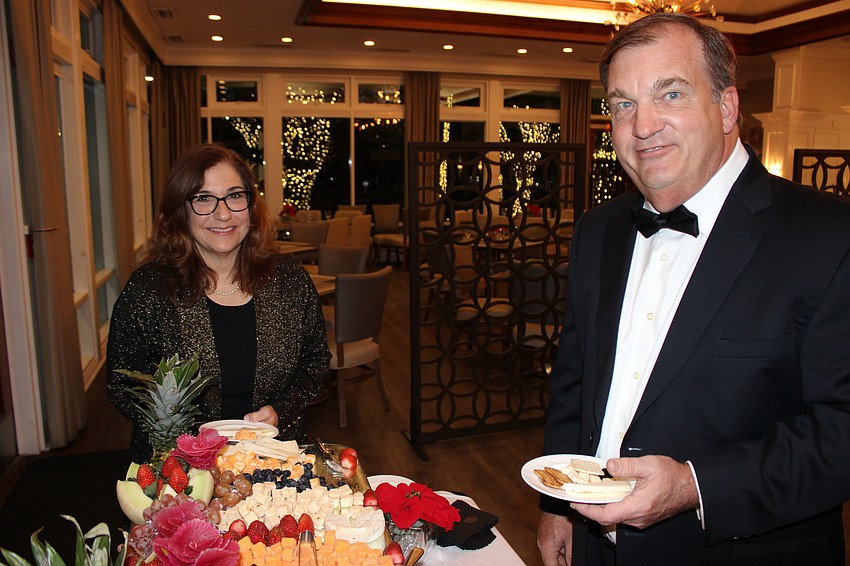 Linda and Dale Wilson enjoy a snack tray at River Club's Rockin' Reindeer Ball. They later enjoyed a full sit-down dinner that was either prime rib or cod.