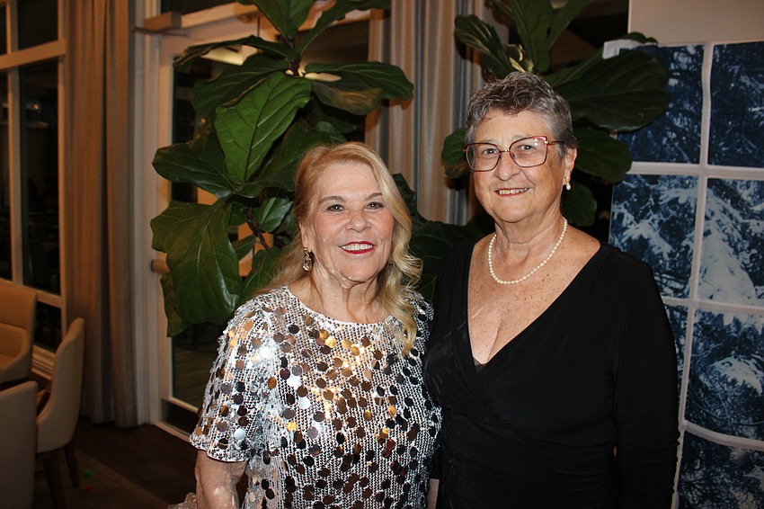 River Club Social Coordinator Maureen Rosin visits with River Club HOA President Carolyn Rowland during the Rockin' Reindeer Ball.