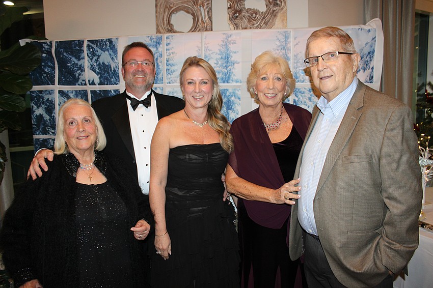 Sandy Sinclair, visiting from the UK, joins Mark and Jane Sinclair, and Susan and Roy Ford at River Club's Rockin' Reindeer Ball.