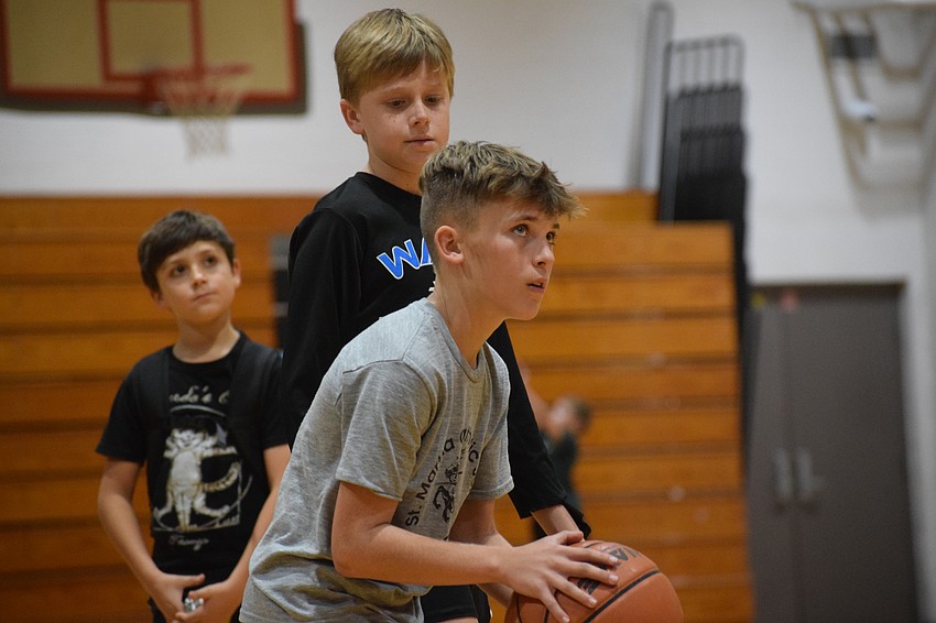 Keegan Mulligan lines up his free-throw attempt as his fellow contestants look on at Carlos E. Haile Middle School during the Lakewood Ranch-Sarasota Elks Hoop Shoot on Monday, Dec. 9.