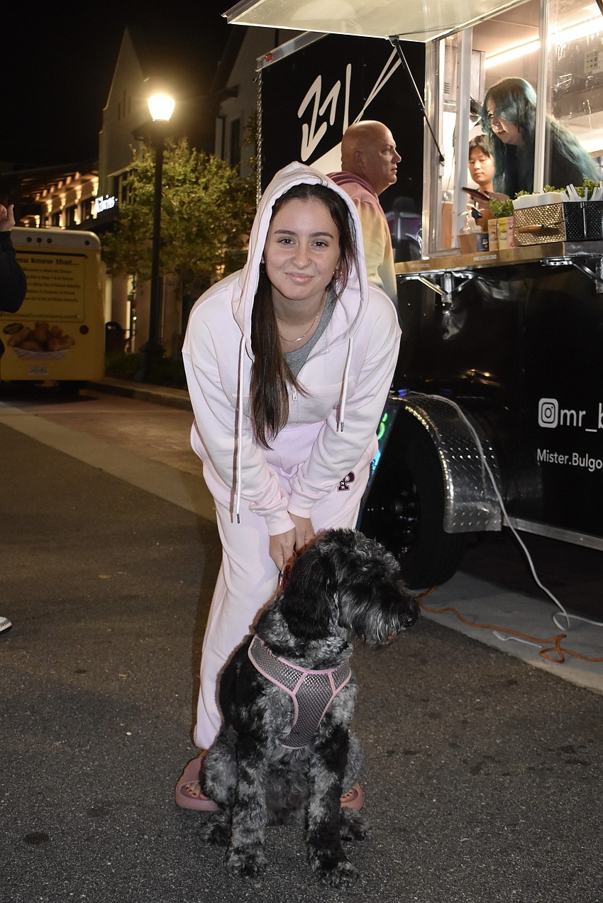 Amelie Rodriguez waits in line at the Mr. Bulgogi truck with her 1-year-old golden doodle Lily.