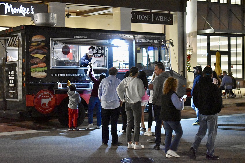 The Tampa Burger Company truck serves a steady line of people all night.