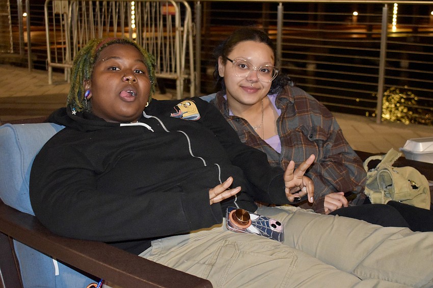 Venice's Zion Redmond and Angelica Rivera relax by the lake after eating pizza cones for dinner, which they say is basically pizza in the shape of a cone.