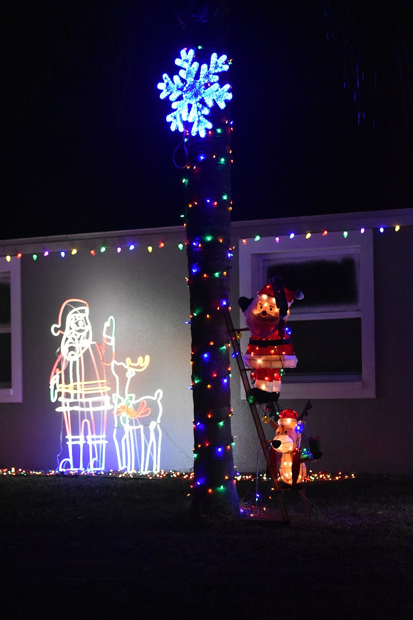 Santa and a reindeer help with decorations at 5041 Indian Mound St. in Cedar Hollow.