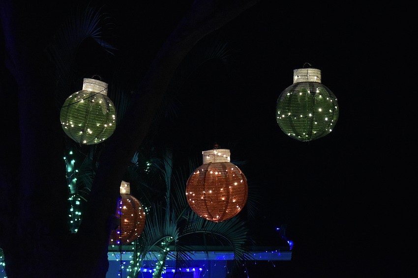Lanterns hang in a tree at 5274 Bunyan St. in Cedar Hollow