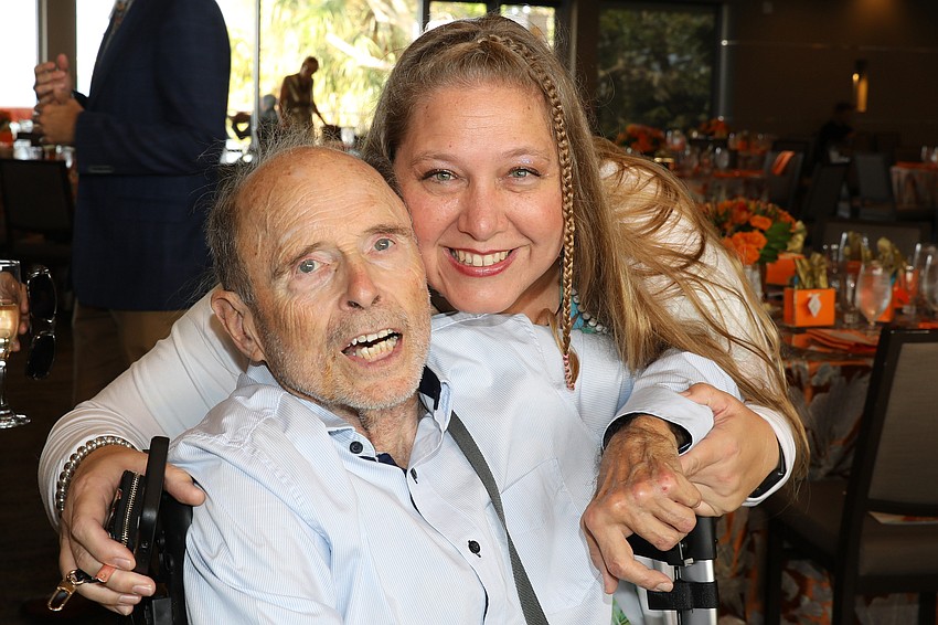 Gana Gilkey gives Bill Bryan a hug at Cause 4 Fashion.