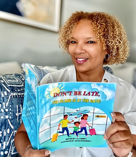 L.R. Corbett with his latest children's book, "Don't Be Late, the Plane is at the Gate." Courtesy photo