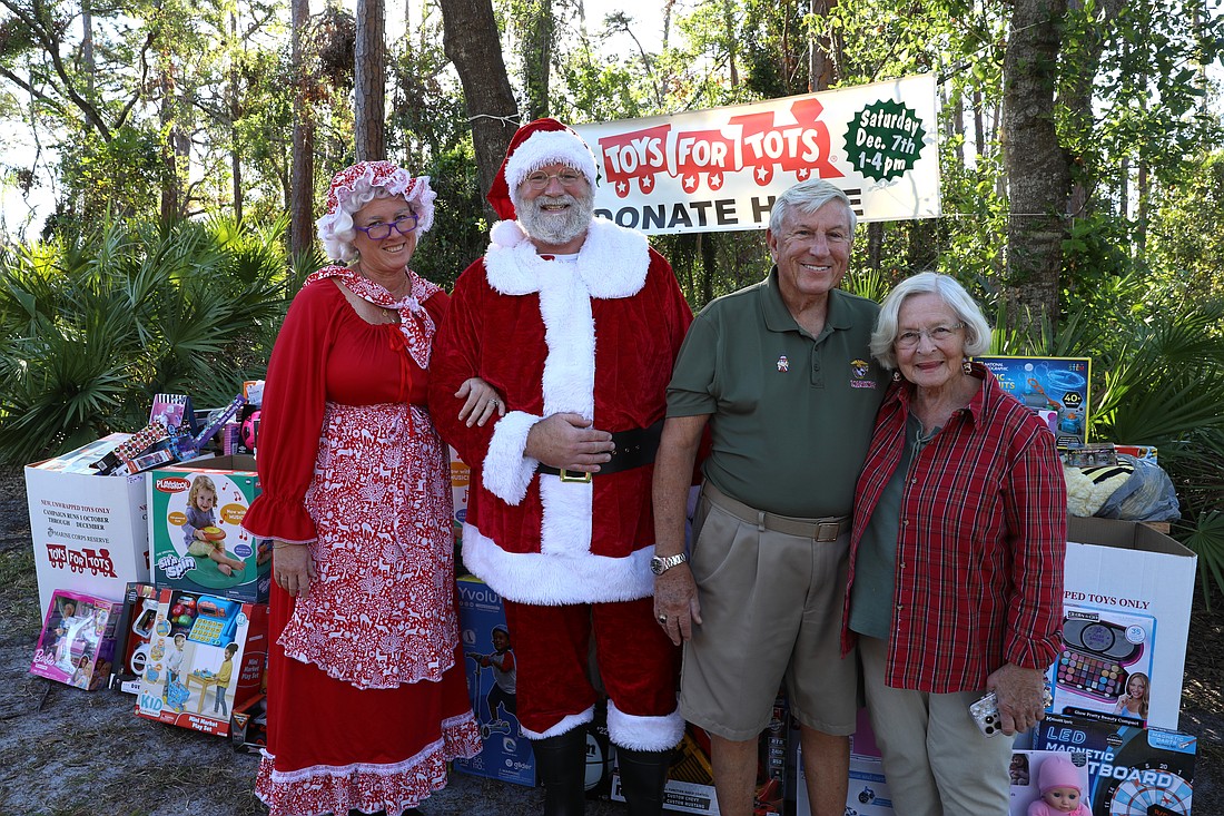 Ellen and Matt Barry with Col. John and Gail Alexander at the Toys for Tots drive.