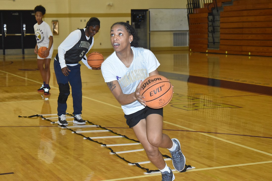 Booker High senior guard Jsiyah Taylor drives to the basket during practice on Dec. 7.