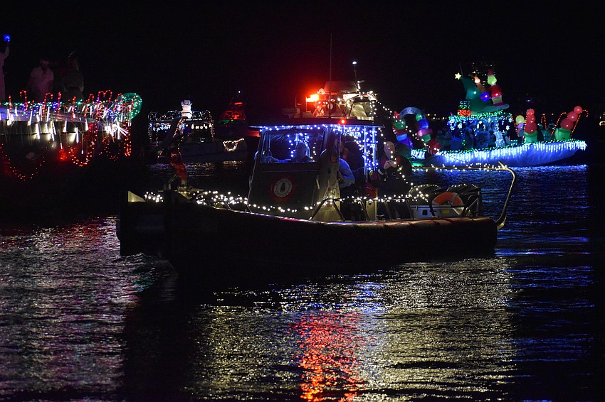 A fireboat approaches on the parade route.