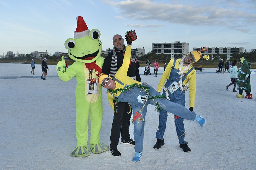 Jim Grimes poses as Floody the Frog with Allison Murphy, Doug Clark and Clarence Lindell of Fort Myers.