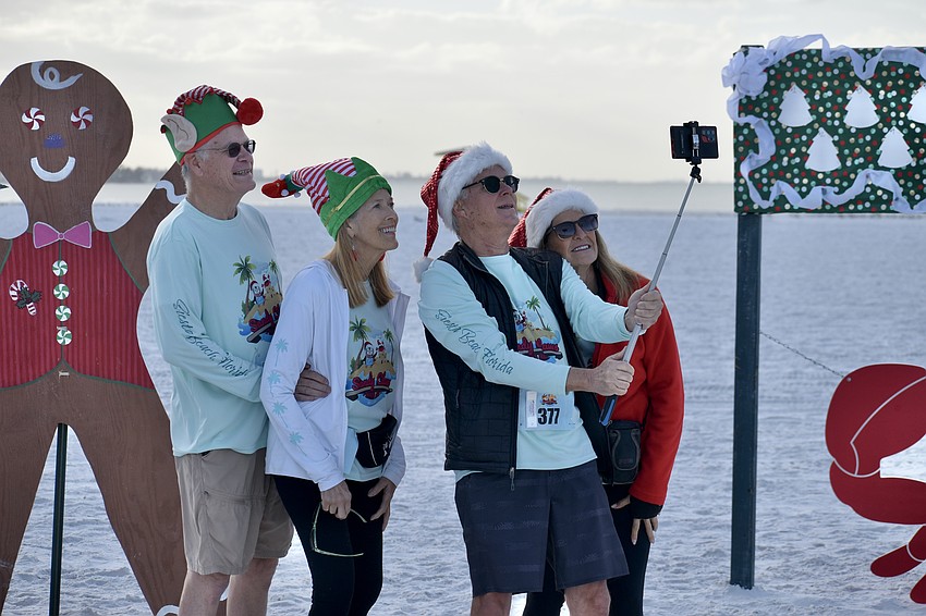 Bill Dundas, his wife Jana Nordquist, Mark Nordquist and Claudia Cardillo take a photo.