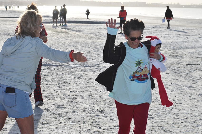 Hermenia Sariol finishes the race.