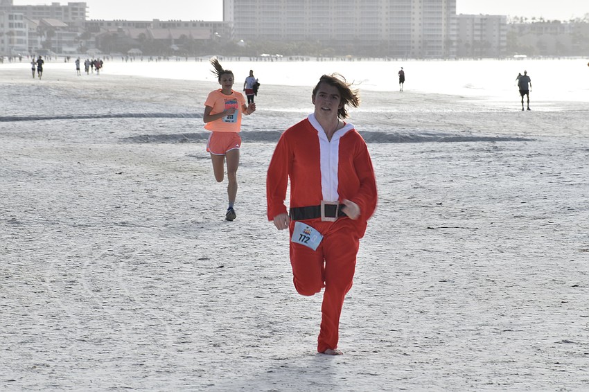 Trenton Johnson, 20 Olivia Hummel, 26, the first overall female to finish the race, approach the finish line.