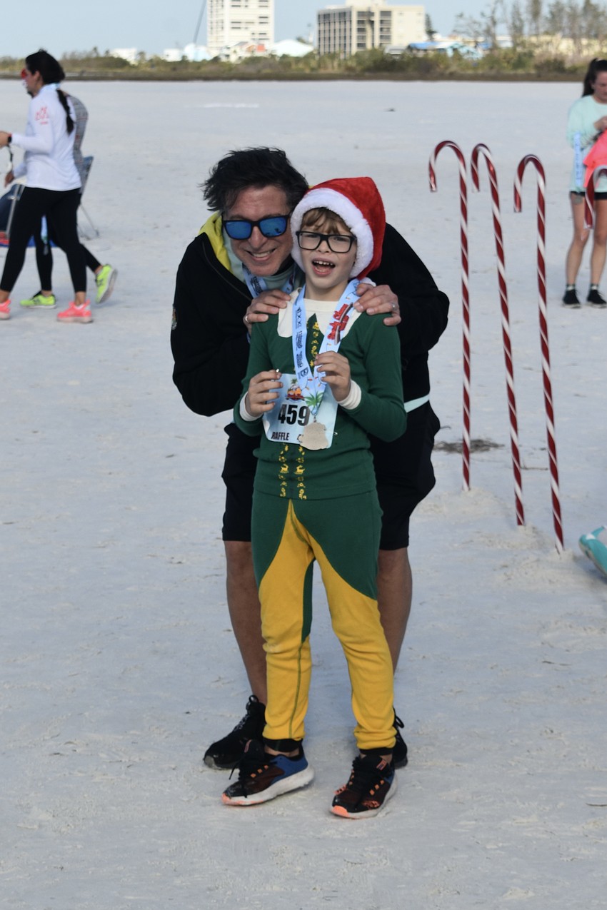 Cary Cavallaro and his son Luke Cavallaro, 6, watch the race.
