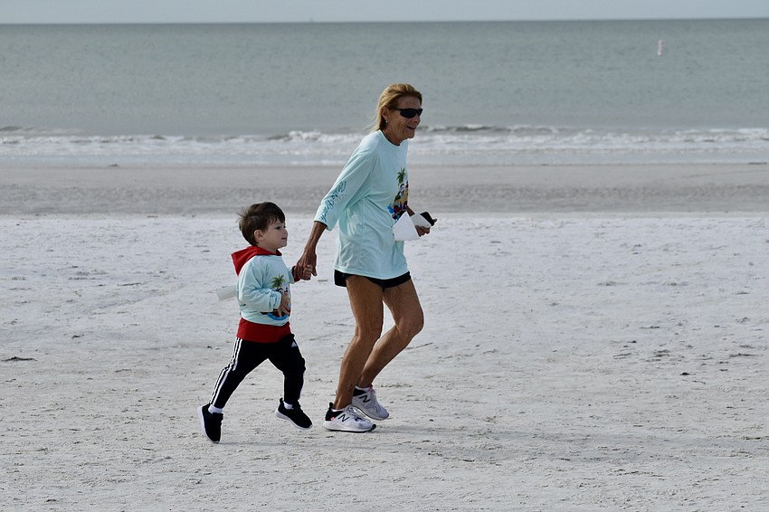 Jack Skuba, 2, races with his grandmother Cathi Skuba.