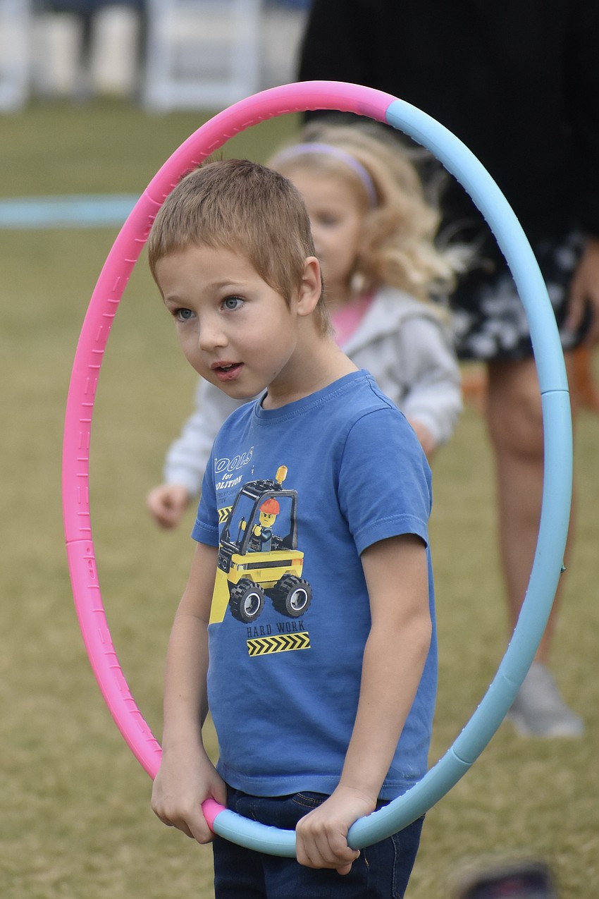 Filip Doubravsky, 4, watches as Santa Claus arrives by golf cart.