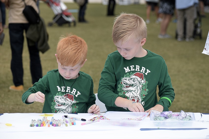 Henry Ross, 5, and Lucas Ross, 8, work on art projects together.