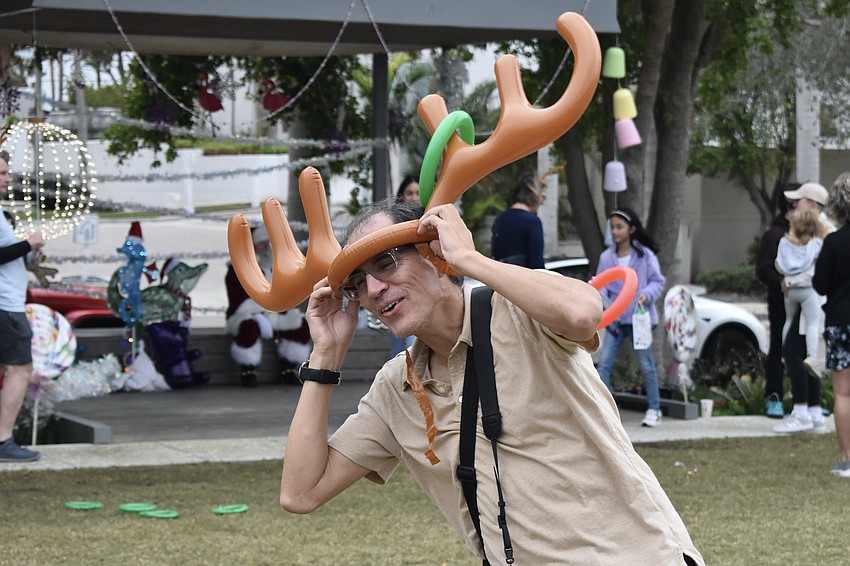 Cesar Rodriguez catches rings on the reindeer antlers.