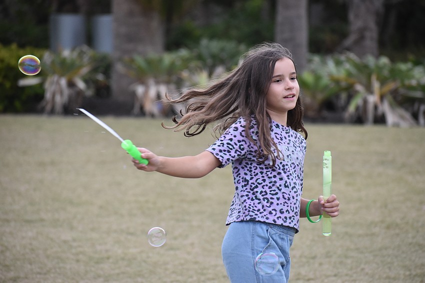 Mila Szykulski, 8, makes bubbles.