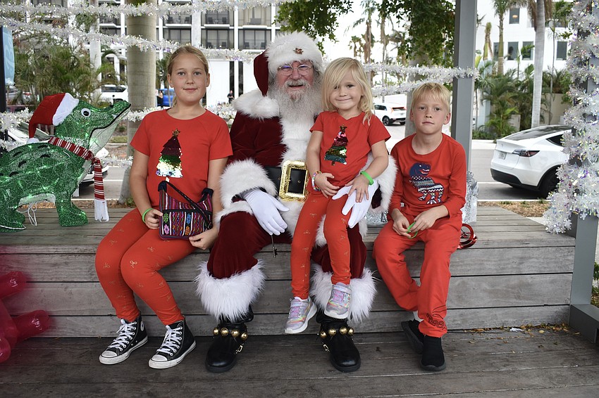 Kira Kirilina, 10, her sister Mia Kirilina, 5 and brother Robert Kirilina, 8 meet Santa Claus.