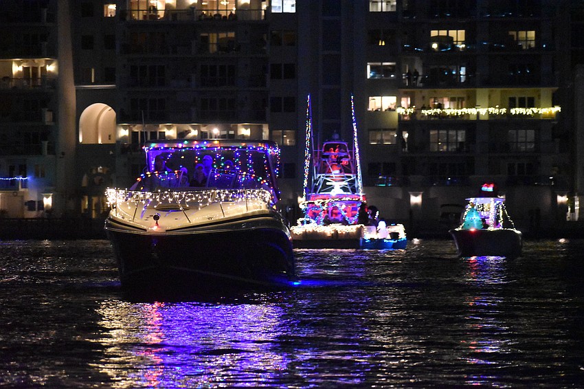 A line of boats approaches, with Shark Bait in front.