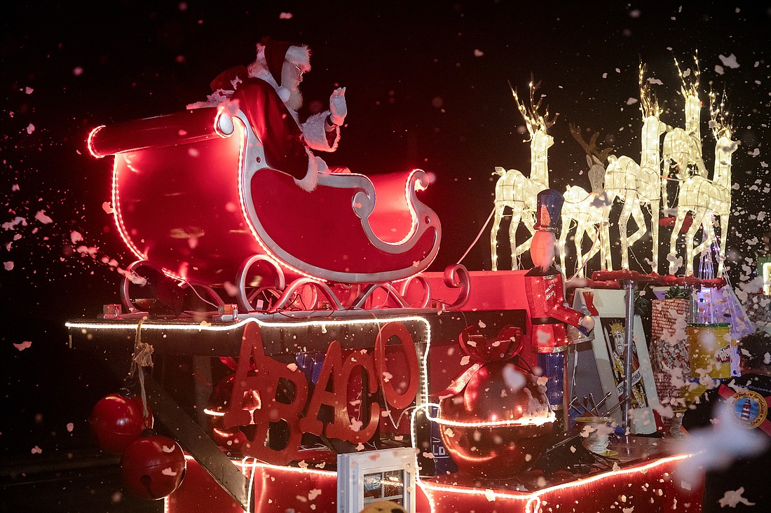 Abaco Windows made sure that Santa and Mrs. Claus made it through the rain to their destination in the Home for the Holidays parade on Saturday, Dec. 14. Photo by Michele Meyers