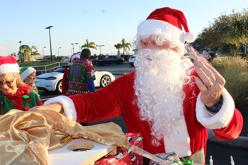 Santa, AKA Ray Hupp, prepares to give out candy canes at the Tara Holiday Golf Cart Parade.